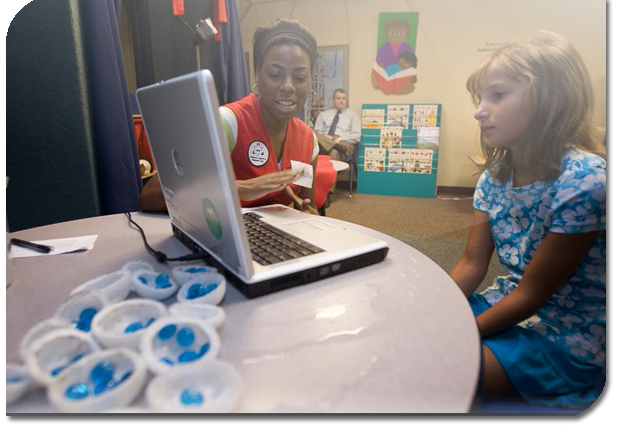 Student and teacher looking at laptop