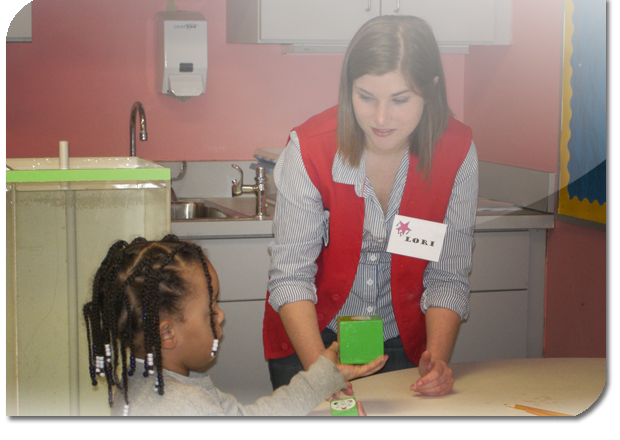 Teacher watches as child plays with cubes
