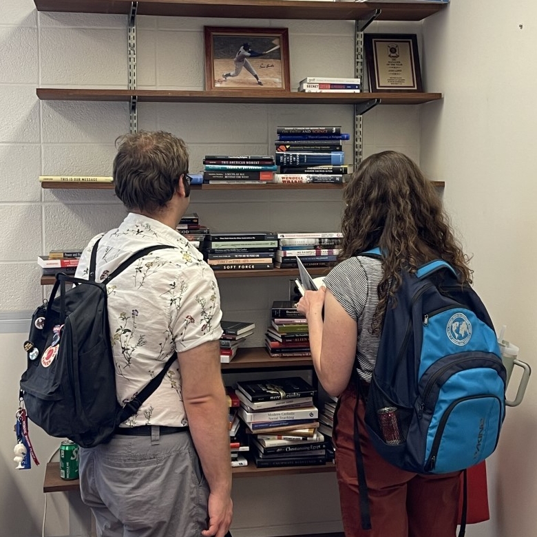 Students looking through books. 