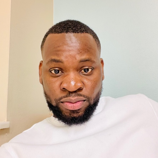 A color photo of Oluwasegun "Isaac" Akinboye wearing a white shirt in front of a white background.