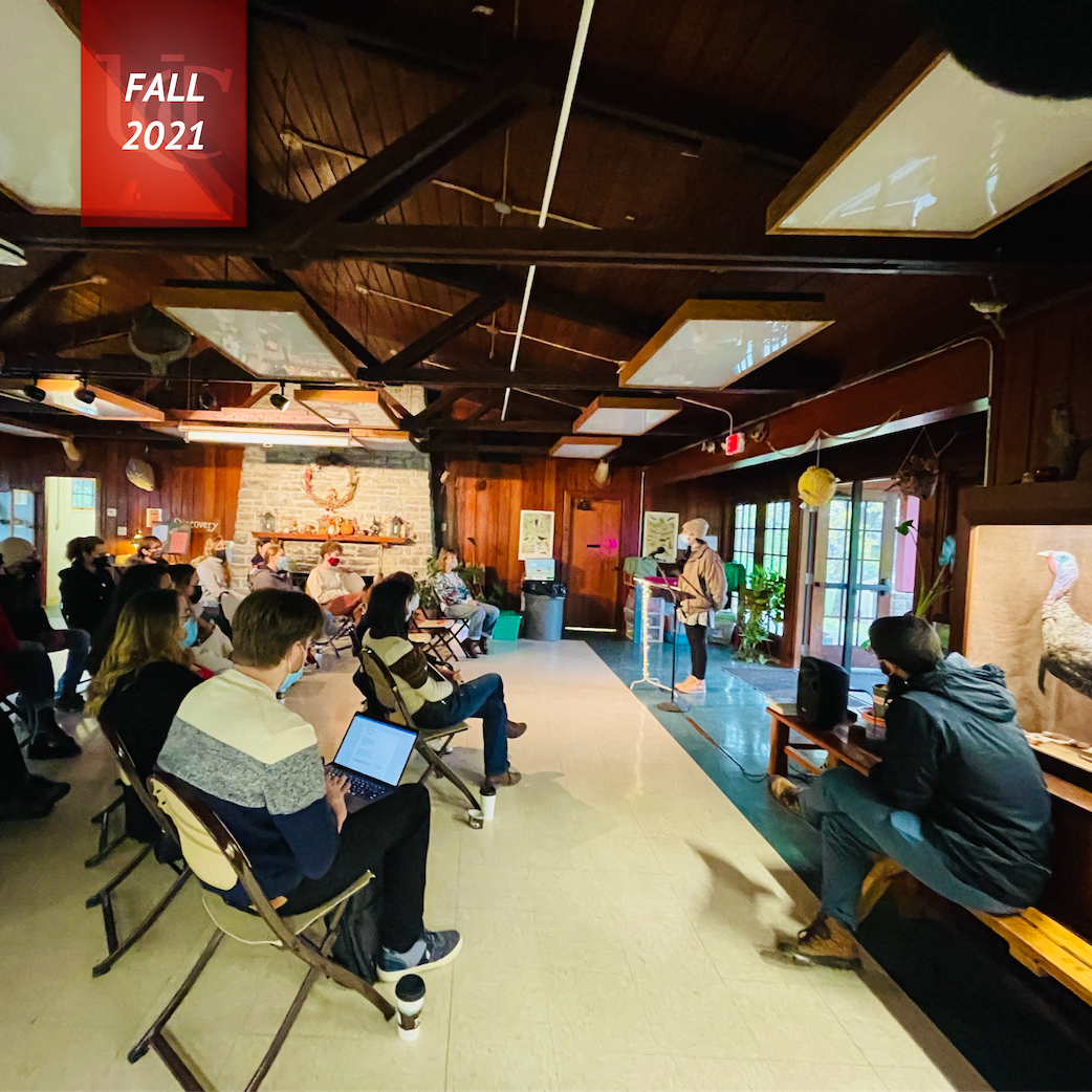 Community of writers listens to a reader in the cozy Laboiteaux Woods Center
