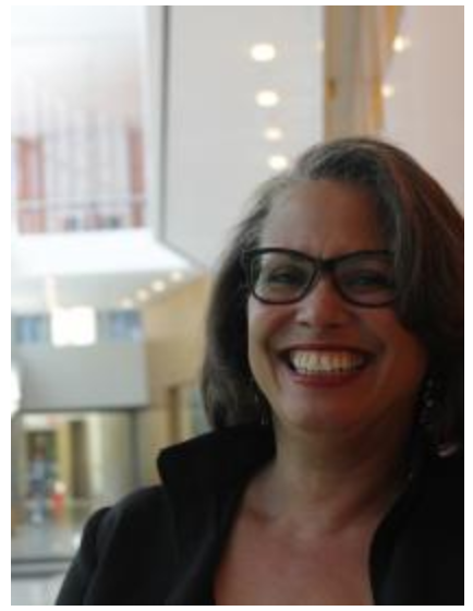 picture of a women with glasses and black hair smiling 